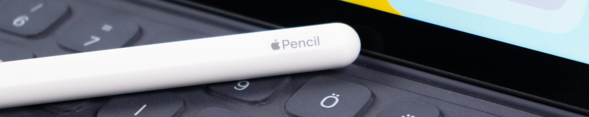 white pencil stylus on grey laptop